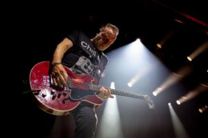 Peter Hook plays guitar